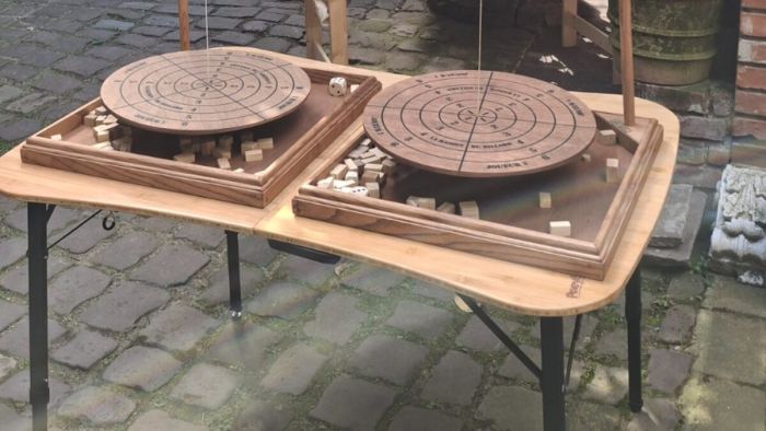 Zwei Bomboleo-Spiele nebeneinander im Innenhof, Holzklötze rund um die Scheibe